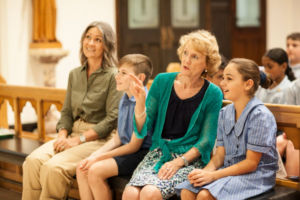 Students and Family Educator sitting and having a conversation inside church