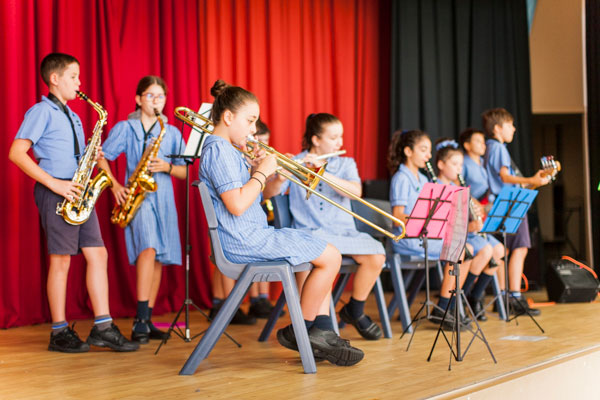 Student band playing instruments on stage